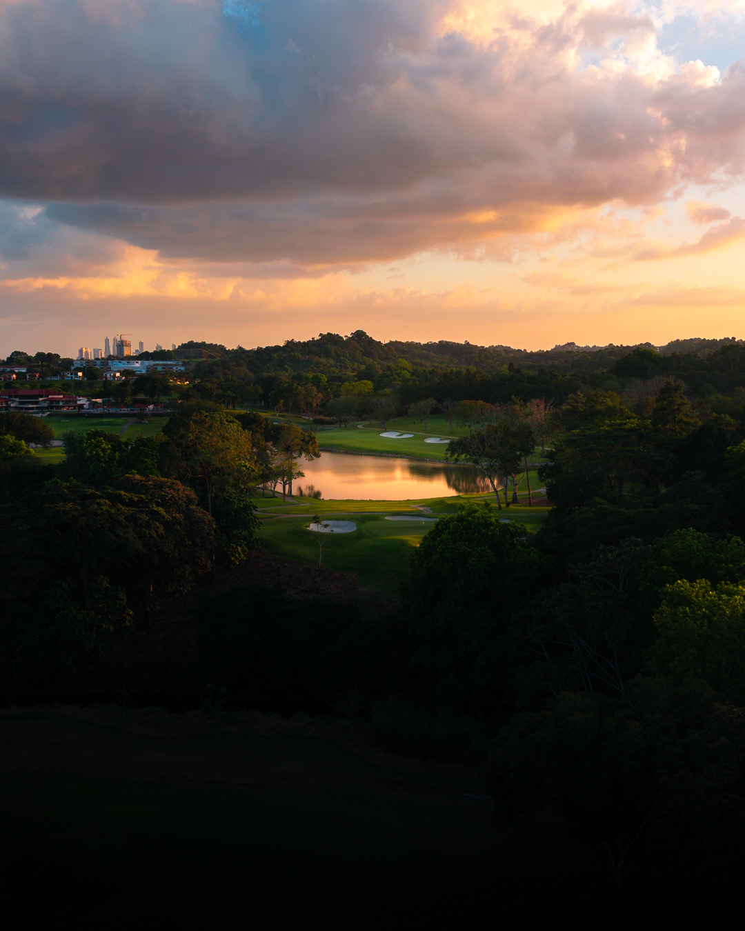 Golf course at dusk with the Panama City skyline on the horizon
